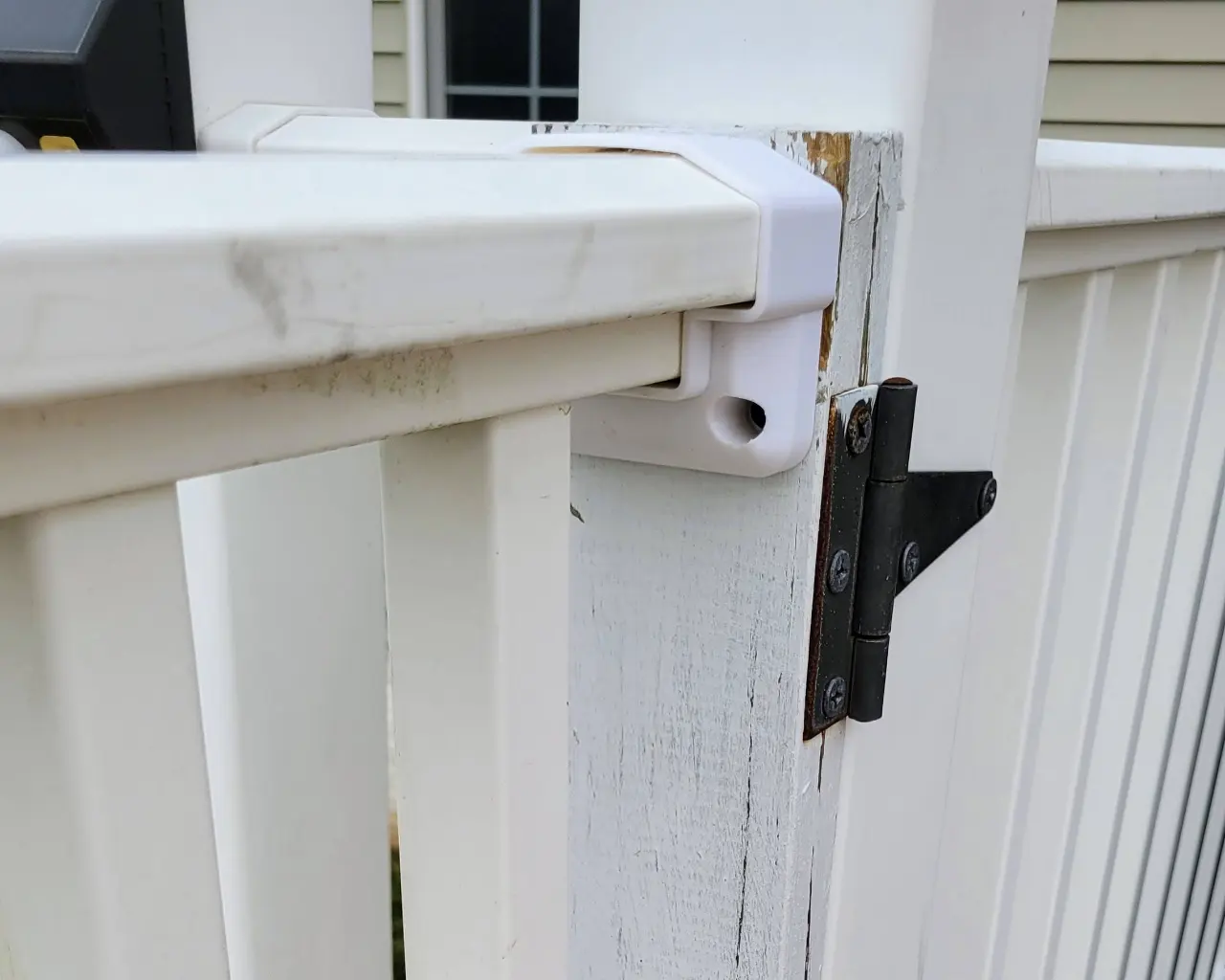 ABS gate mount bracket installed on a post